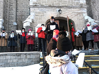 carol singing on the church steps